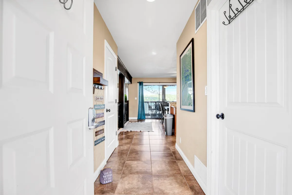 An inviting entryway with an open door leading to an outdoor space, accented by welcoming hallway décor. The scene hints at transitions between indoor comfort and outdoor adventure, perfect for gathering before setting out or returning from local explorations.